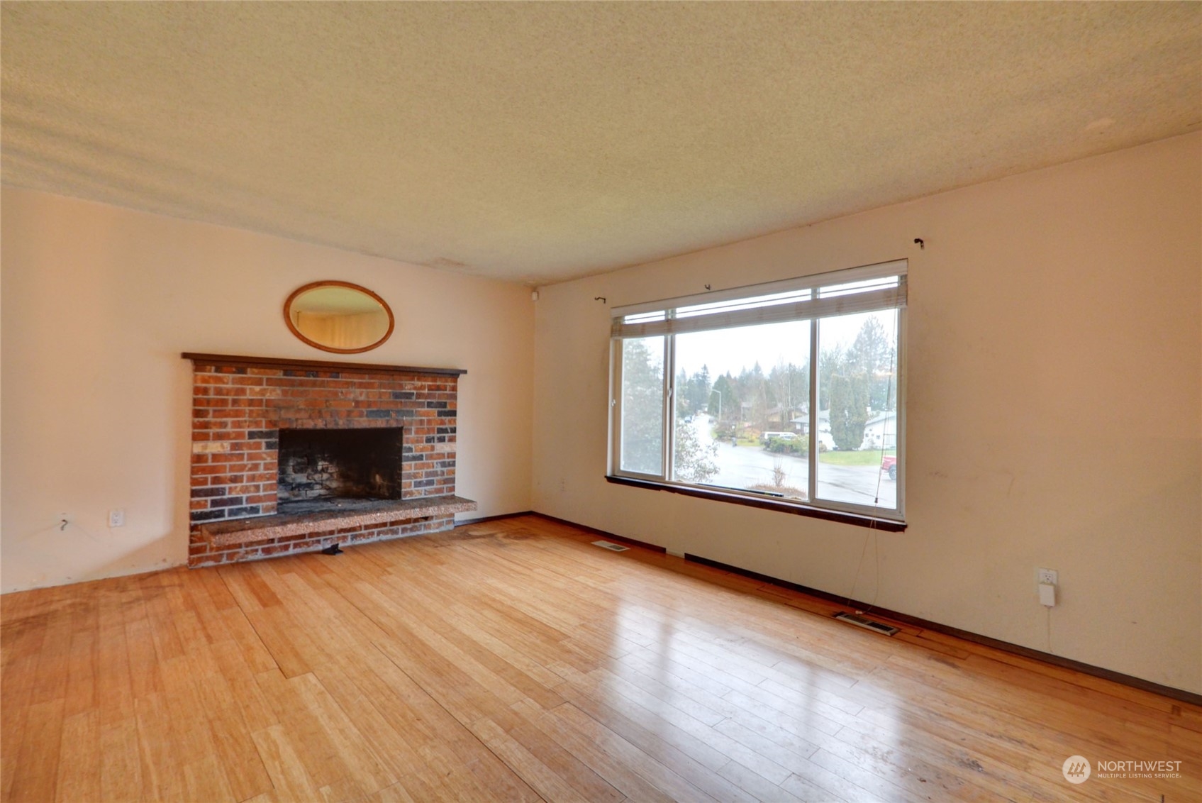 16913 29th Drive Southeast Bothell, WA 98012 - Photo 6 of 17 a view of empty room with wooden floor and fireplace