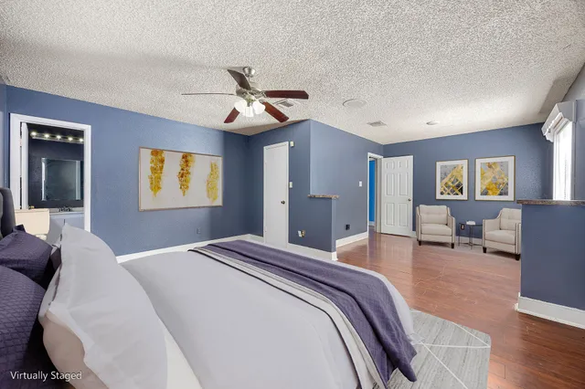 a spacious bedroom with a bed and a chandelier