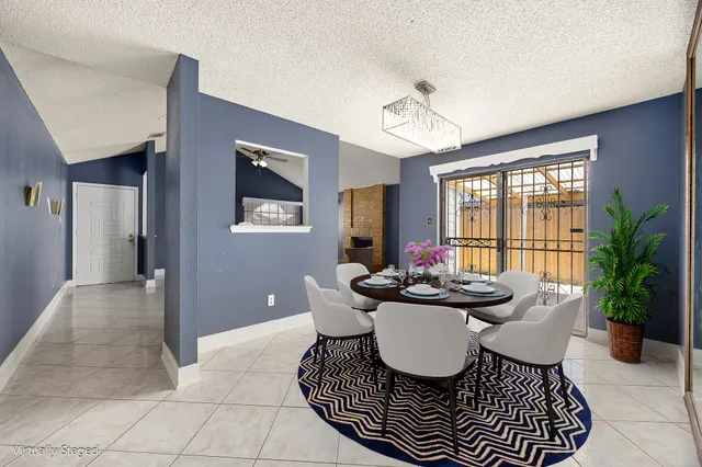 a dining room with furniture a chandelier and window