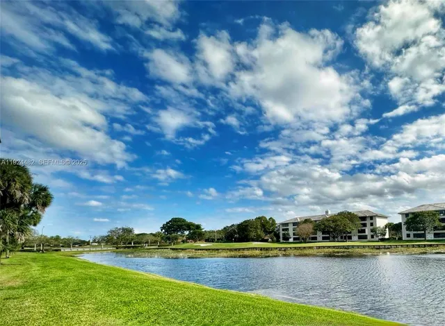 a view of a lake with houses in the back