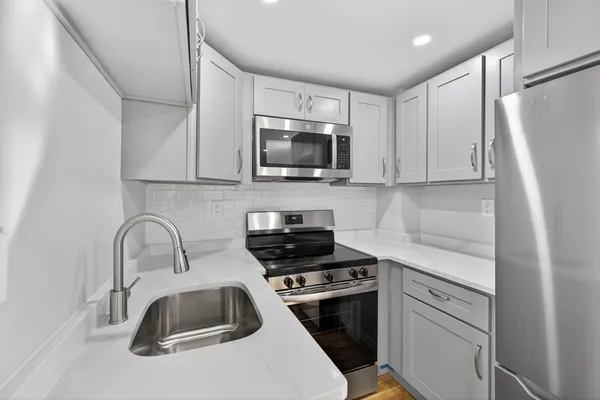 a kitchen with a sink a stove and refrigerator