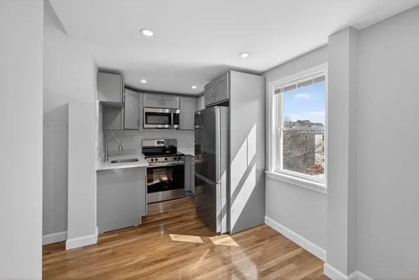 a kitchen with stainless steel appliances granite countertop a refrigerator and a stove top oven