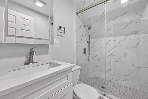 a bathroom with a sink toilet and shower