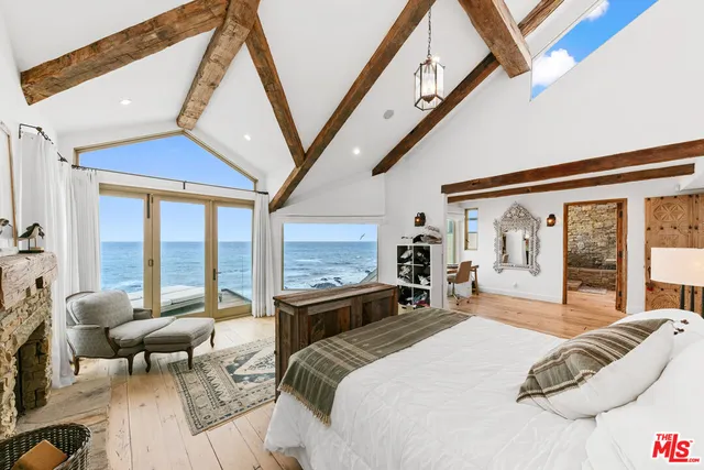 a spacious bedroom with a large bed and a large window