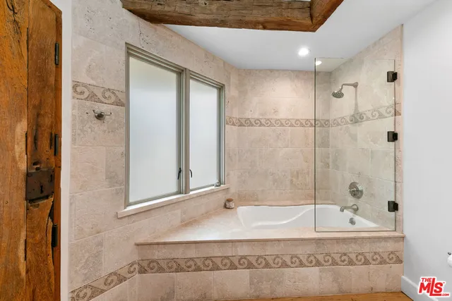 a bathroom with a bathtub and a shower