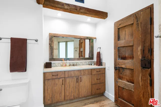 a bathroom with a sink a mirror and a shower