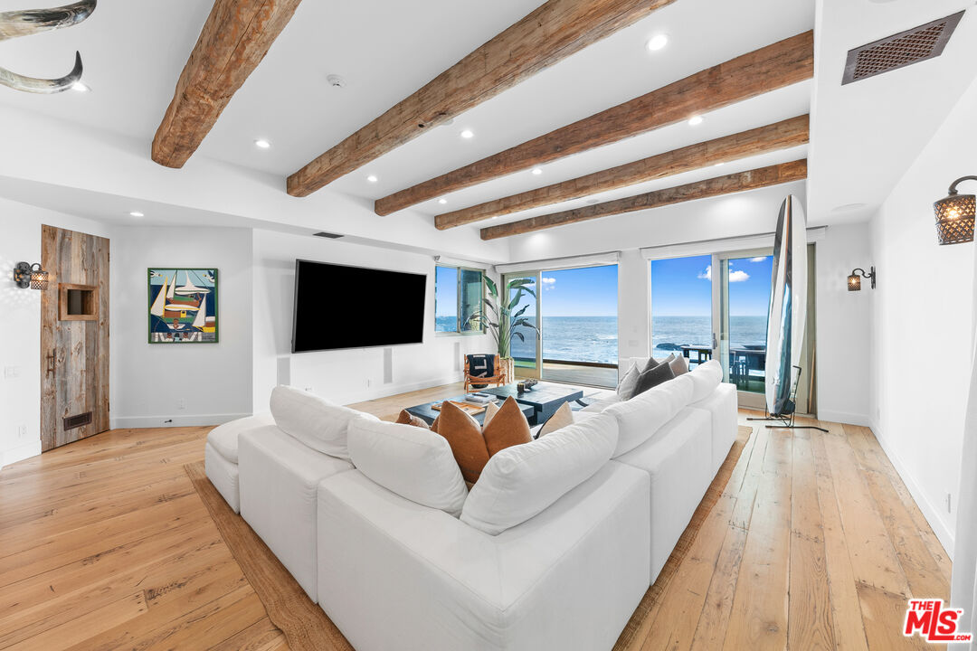 24920 Malibu Road Malibu, CA 90265 - Photo 30 of 49 a living room with furniture and a flat screen tv