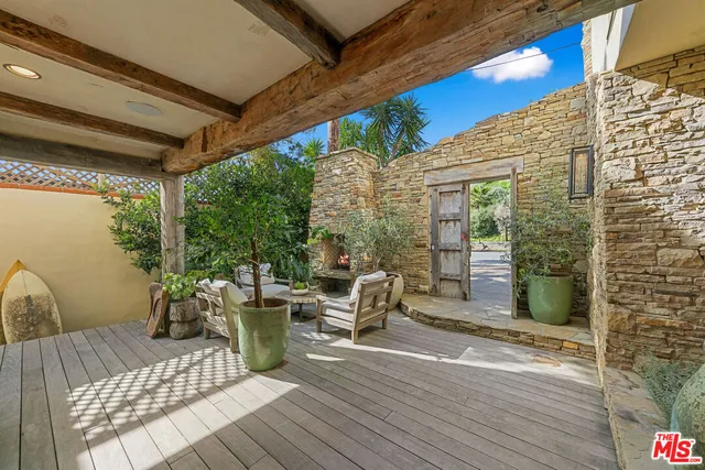 a view of a patio with table and chairs and wooden floor