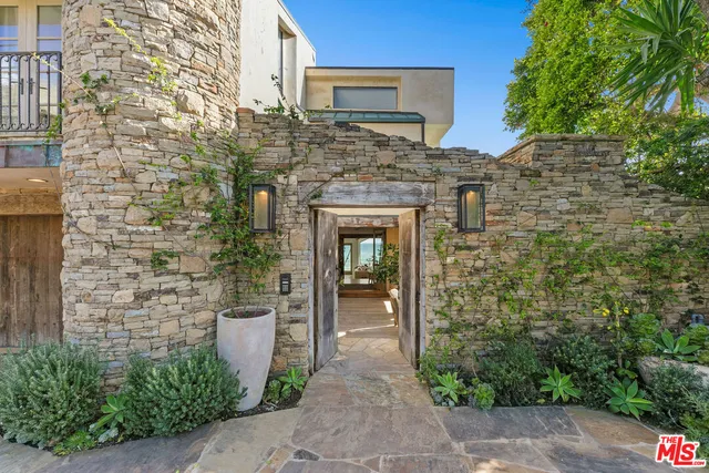a stone house with a door and windows
