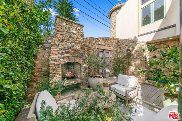 a view of a patio with table and chairs potted plants with wooden floor