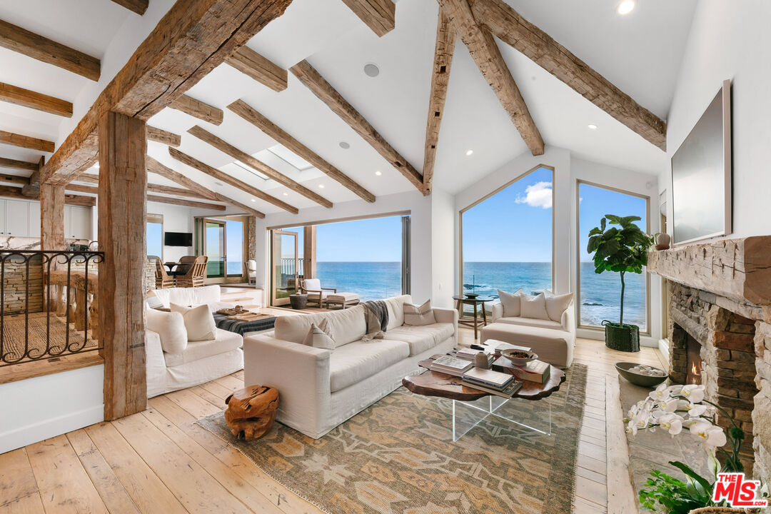 24920 Malibu Road Malibu, CA 90265 - Photo 7 of 49 a living room with furniture and a fireplace