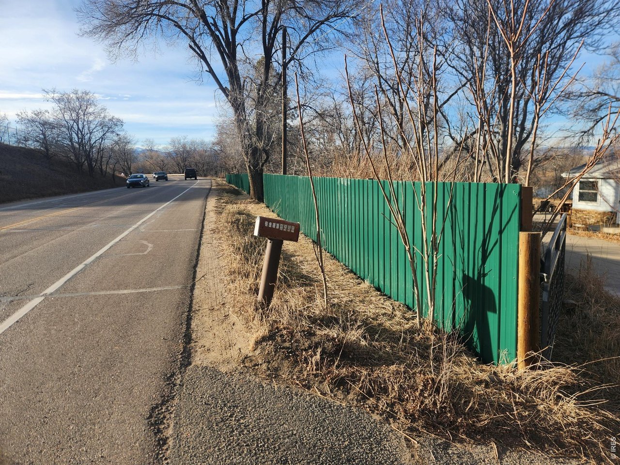6903 Valmont Road Boulder, CO 80301 - Photo 46 of 47 Installation of new Valmont Road fencing is in progress, highlighted by loden-green steel panels and sturdy metal posts professionally embedded in concrete.