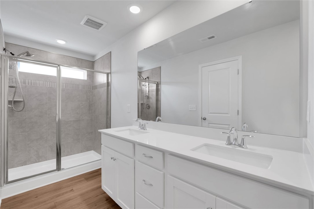 515 Brasstown Court Pendleton, SC 29670 - Photo 12 of 25 This clean and bright bathroom boasts a spacious double vanity and modern shower.