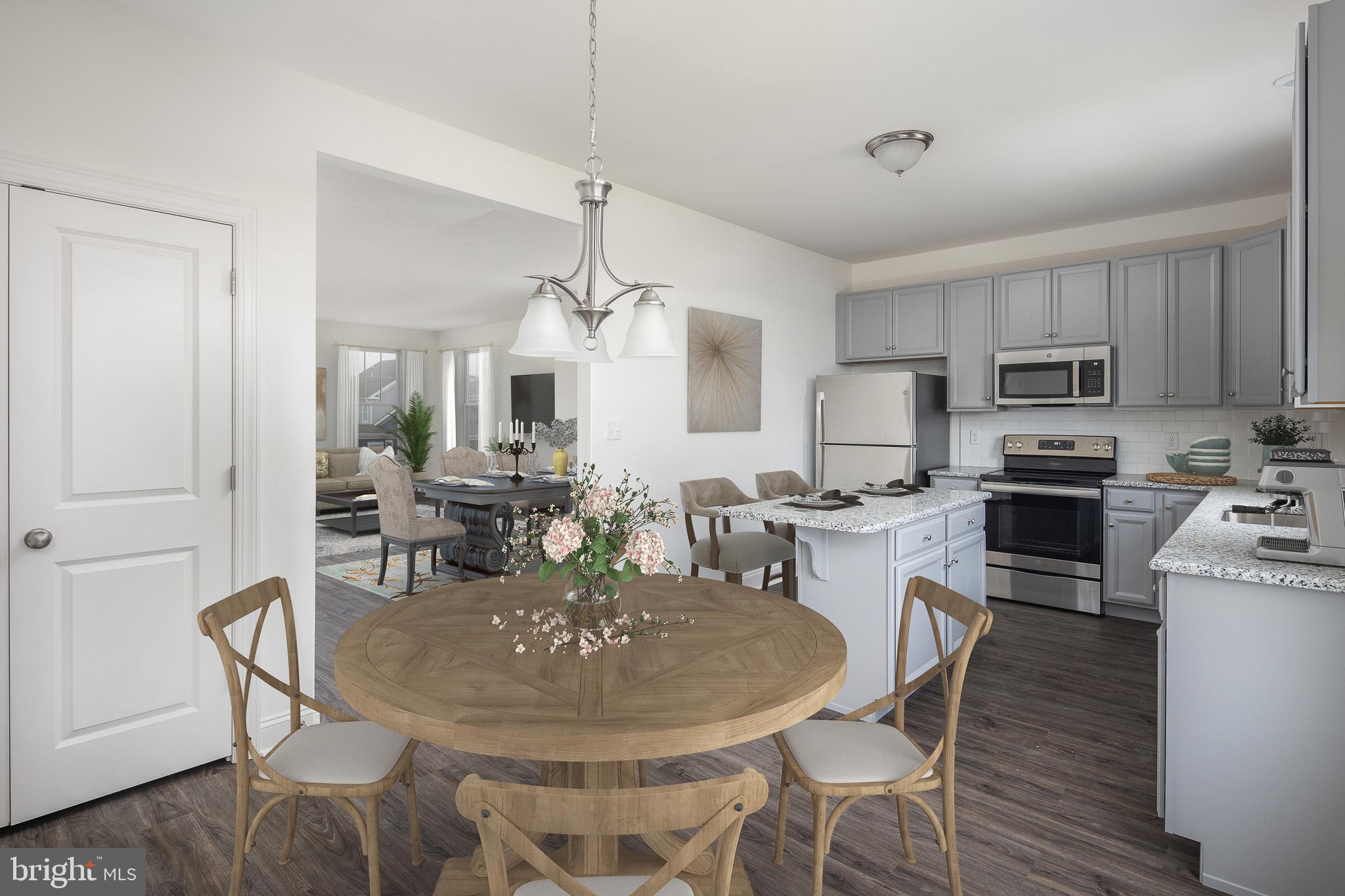 873 Mapleton Avenue, Unit 188 Middletown, DE 19709 - Photo 4 of 24 a dining room with furniture a chandelier and kitchen view