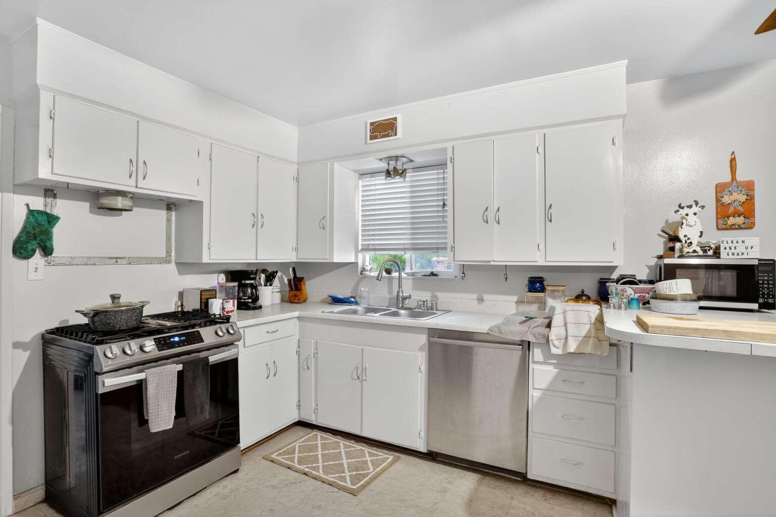 7408 Bridge Lane Redding, CA 96002 - Photo 12 of 25 a kitchen with cabinets appliances a sink and a counter top