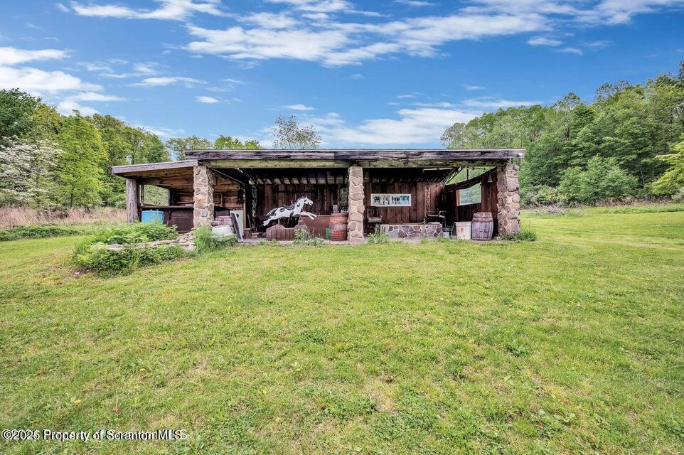 2694 Ransom Road Clarks Summit, PA 18411 - Photo 15 of 16 a view of a house with backyard and porch