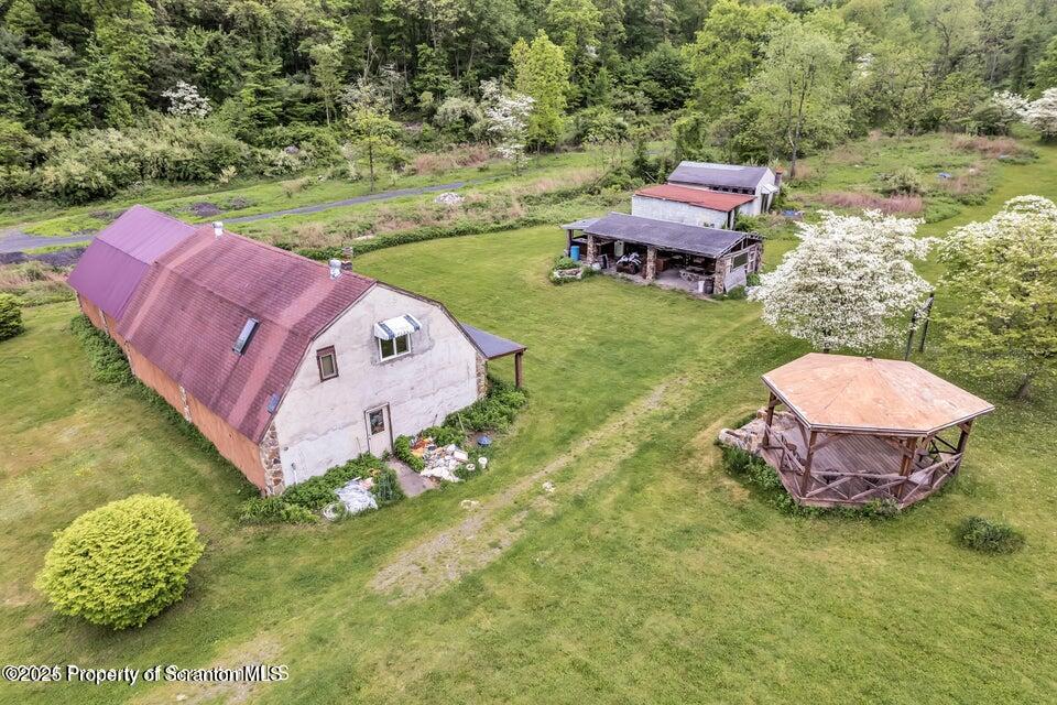 2694 Ransom Road Clarks Summit, PA 18411 - Photo 3 of 16 a view of a backyard with table and chairs potted plants and large tree