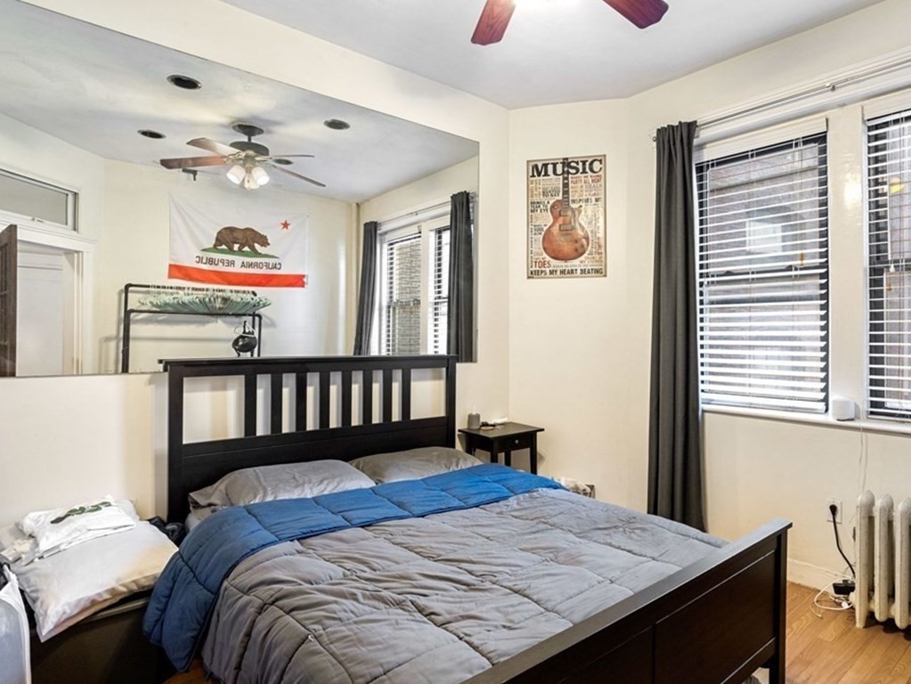 52 Charlesgate East, Unit 155 Boston, MA 02215 - Photo 2 of 9 a bedroom with a bed and wooden floor
