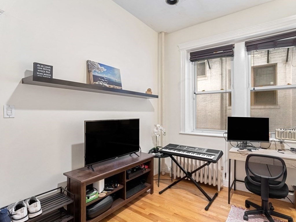 52 Charlesgate East, Unit 155 Boston, MA 02215 - Photo 4 of 9 a living room with furniture and a flat screen tv