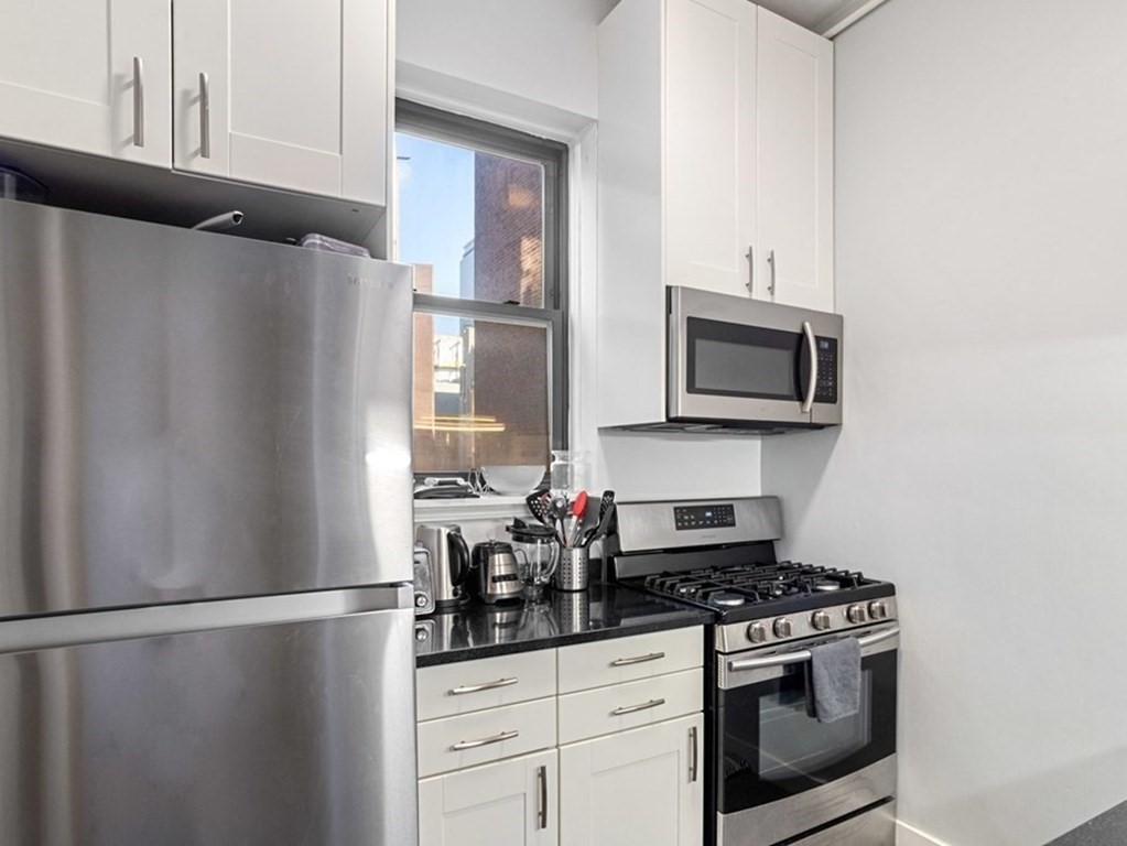 52 Charlesgate East, Unit 155 Boston, MA 02215 - Photo 5 of 9 a kitchen with stainless steel appliances a refrigerator stove and microwave