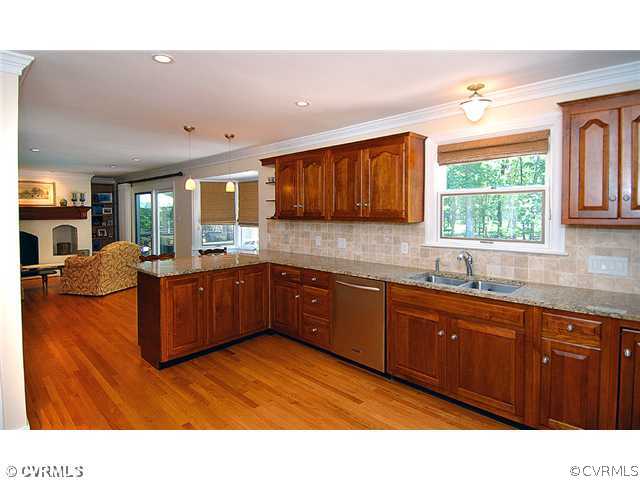 1939 Albion Road Midlothian, VA 23113 - Photo 3 of 18 a kitchen with stainless steel appliances kitchen island granite countertop wood cabinets a window and a sink