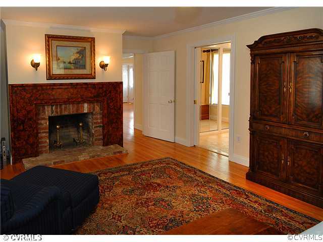 1939 Albion Road Midlothian, VA 23113 - Photo 9 of 18 a living room with a fireplace and a wooden floor