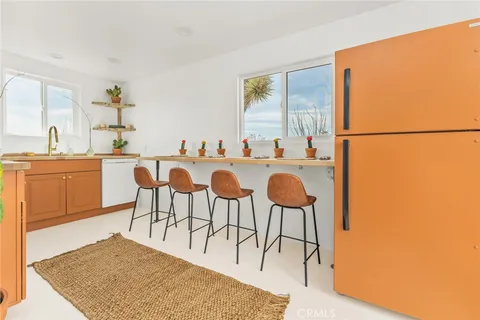 a view of a dining room with furniture and a rug