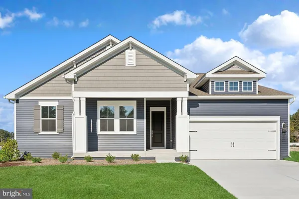 a front view of a house with a garden and yard