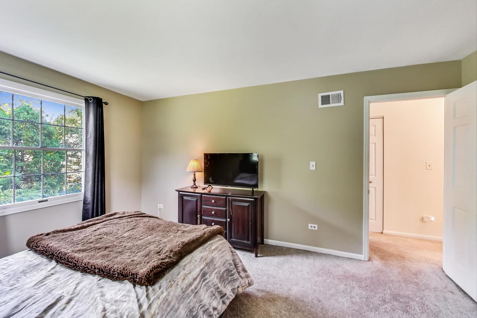 2210 Freeman Court Inverness, IL 60067 - Photo 34 of 56 a bedroom with a bed and a flat screen tv