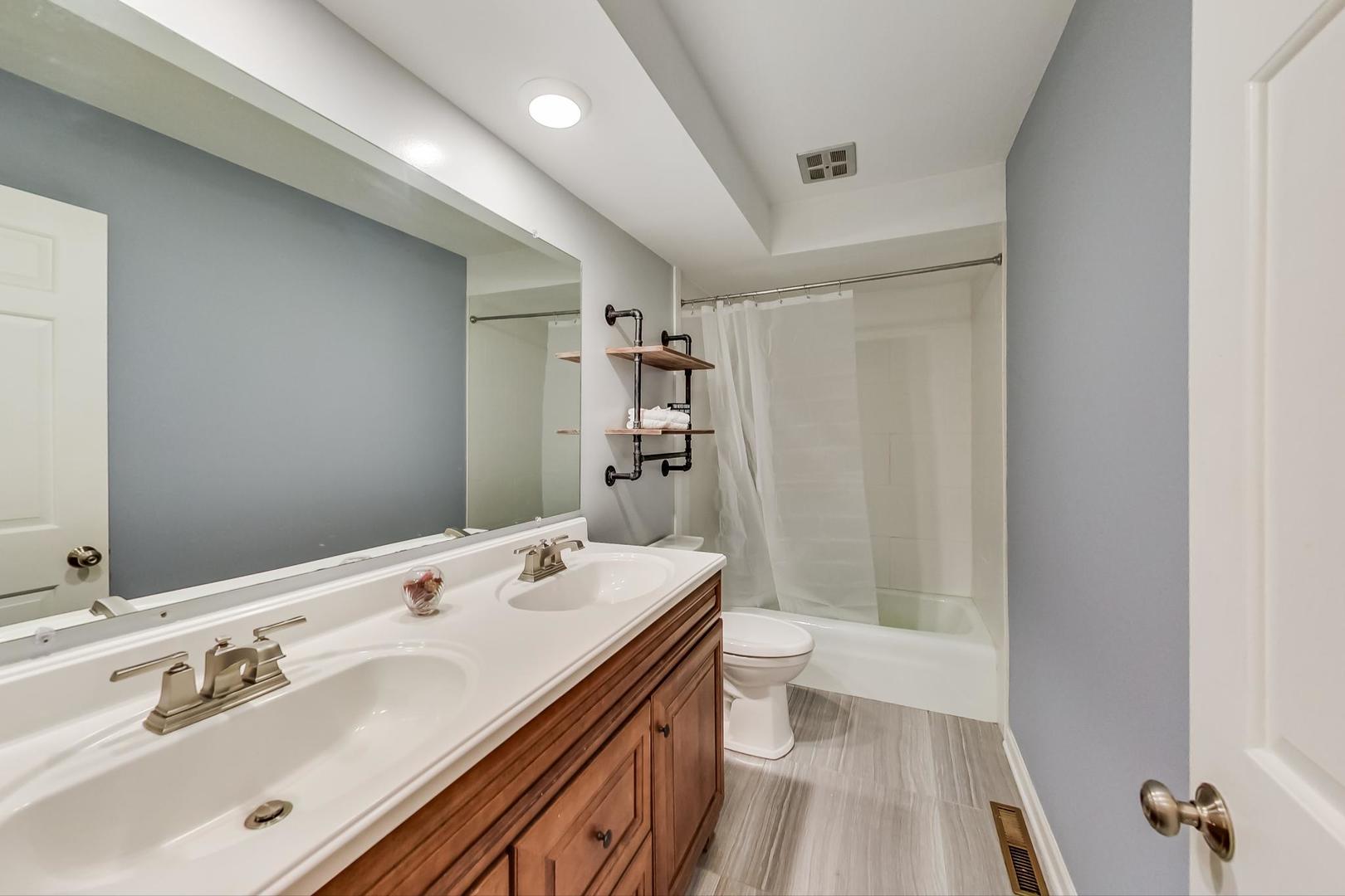 2210 Freeman Court Inverness, IL 60067 - Photo 36 of 56 a bathroom with a sink a mirror and a shower