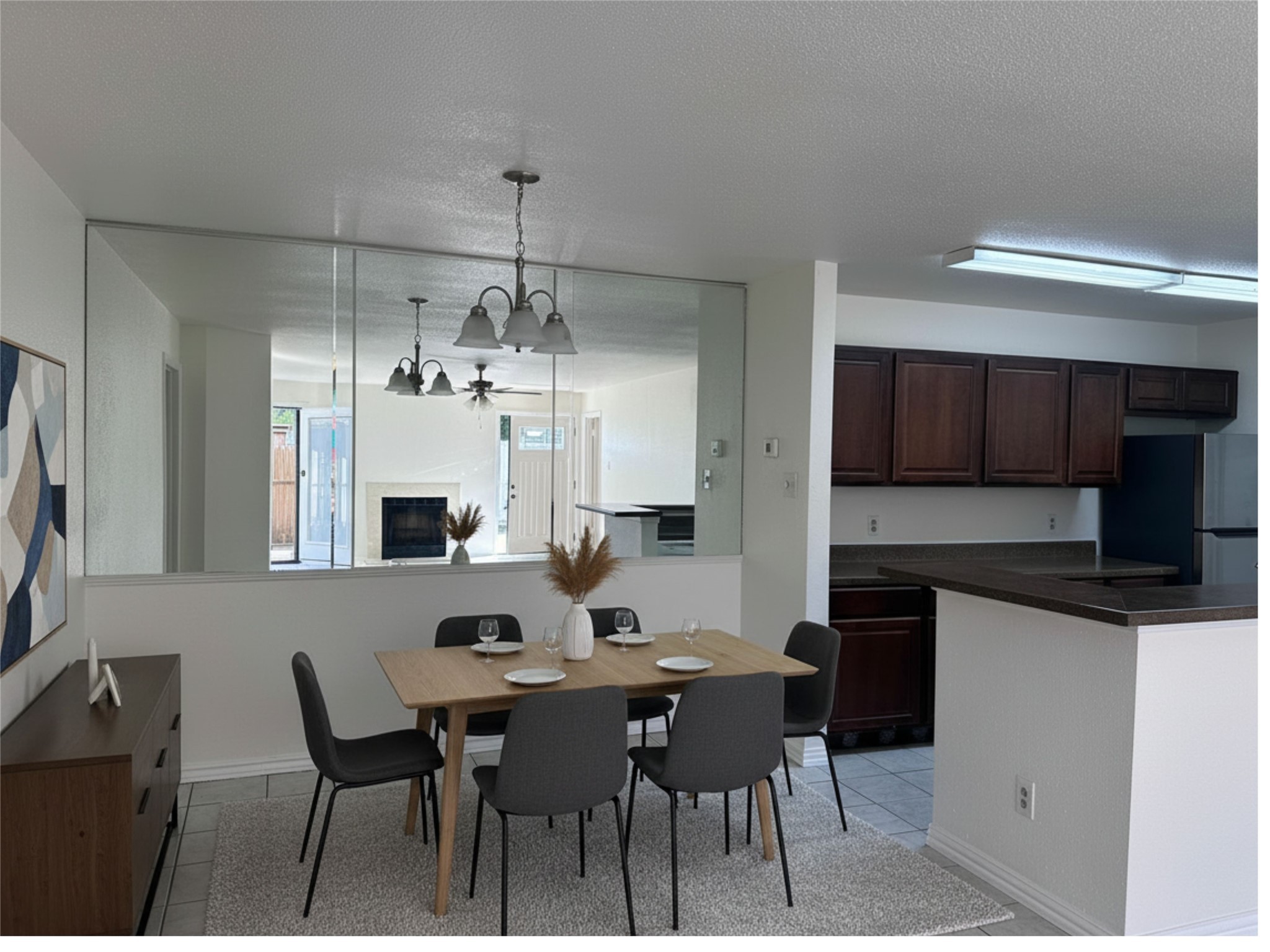10859 Braes Bend Drive Houston, TX 77071 - Photo 3 of 7 a kitchen with stainless steel appliances kitchen island granite countertop a dining table chairs and a refrigerator