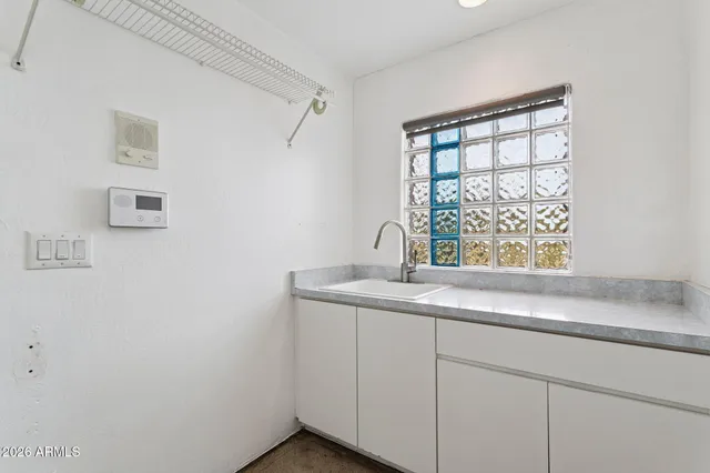 a view of an house with backyard and sitting area