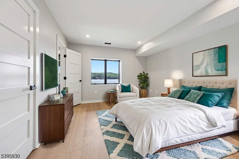 12 Rocky Point Road West Milford, NJ 07421 - Photo 25 of 50 a spacious bedroom with a large bed and a flat screen tv