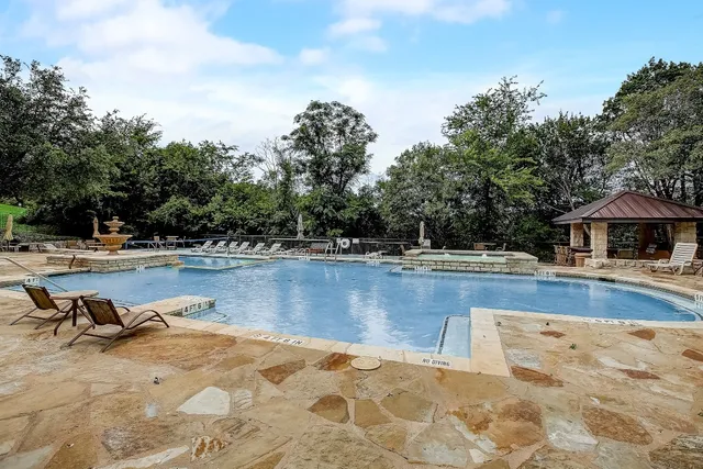 a view of a swimming pool with a lounge chair