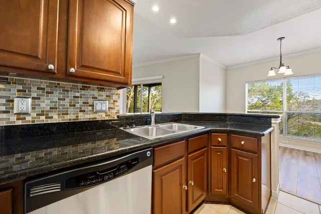 a kitchen with stainless steel appliances granite countertop a sink stove and cabinets