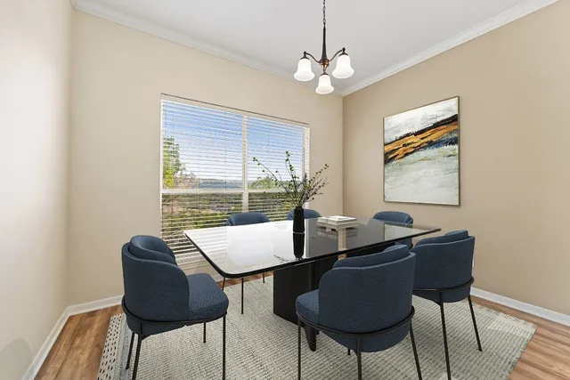 a view of a dining room with furniture and window