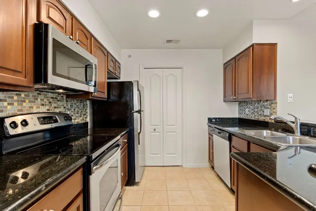 a kitchen with a stove microwave and sink
