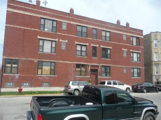 2452 West Iowa Street, Unit 4 Chicago, IL 60622 - Photo 1 of 1 a front view of a building with lot of cars parked
