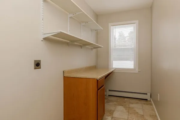a utility room with cabinets and a window