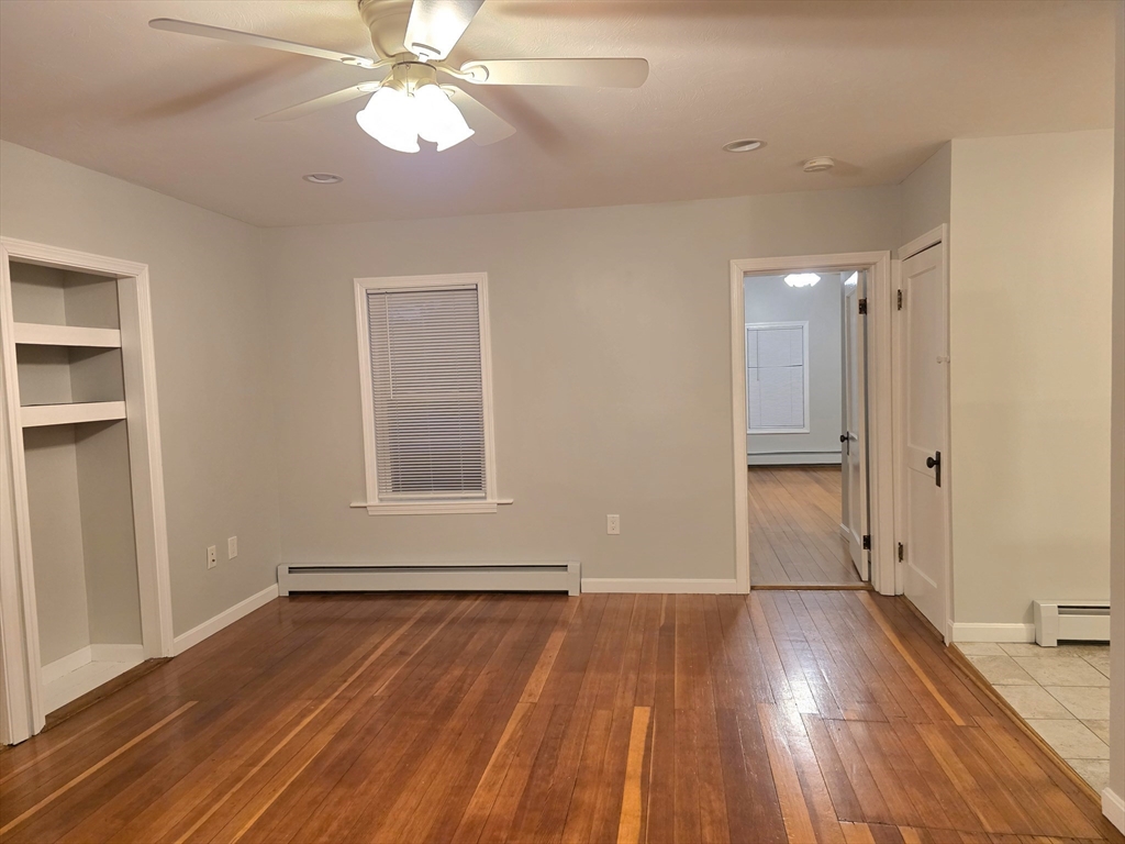 184 Minott Road, Unit 1 Gardner, MA 01440 - Photo 8 of 13 a view of an empty room with wooden floor and a window