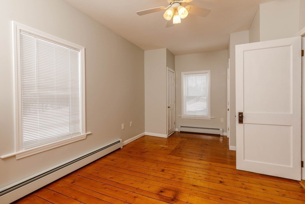 184 Minott Road, Unit 1 Gardner, MA 01440 - Photo 9 of 13 a view of an empty room with wooden floor and a window