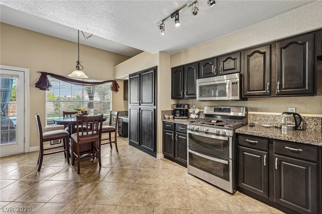 5236 Saranac Road Las Vegas, NV 89130 - Photo 19 of 52 Tile flooring and granite countertops in Kitchen