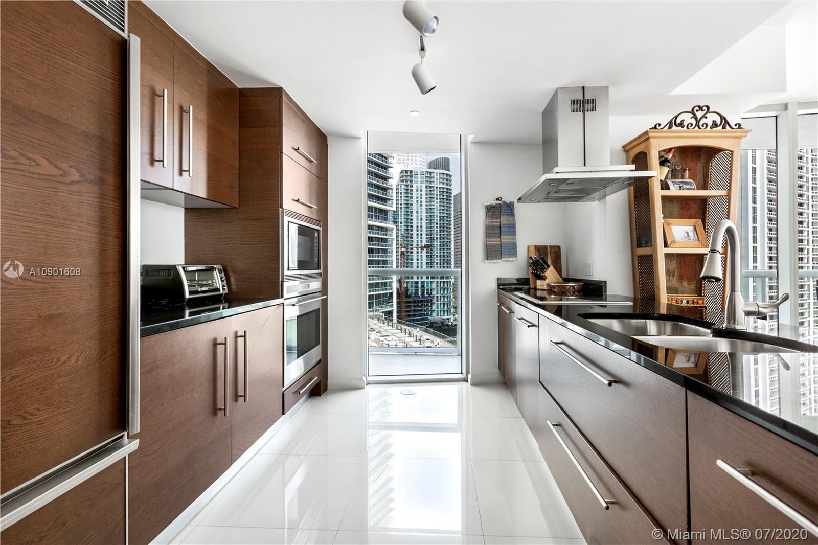 495 Brickell Avenue, Unit 1802 Miami, FL 33131 - Photo 3 of 30 a kitchen with stainless steel appliances a stove sink and cabinets