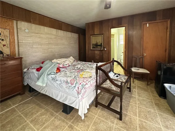 a bedroom with a bed a table and chair