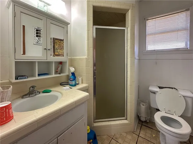 a bathroom with a sink toilet and mirror