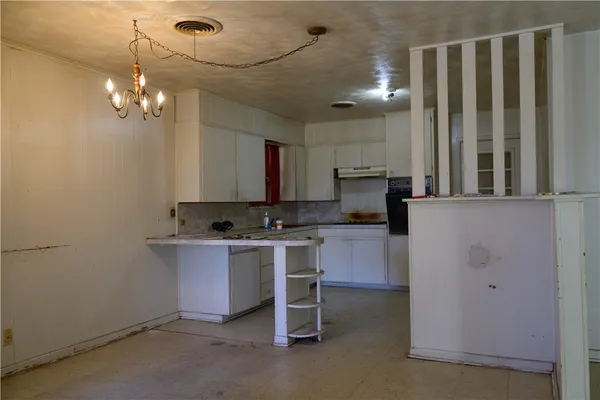 a kitchen with kitchen island a sink stainless steel appliances and cabinets