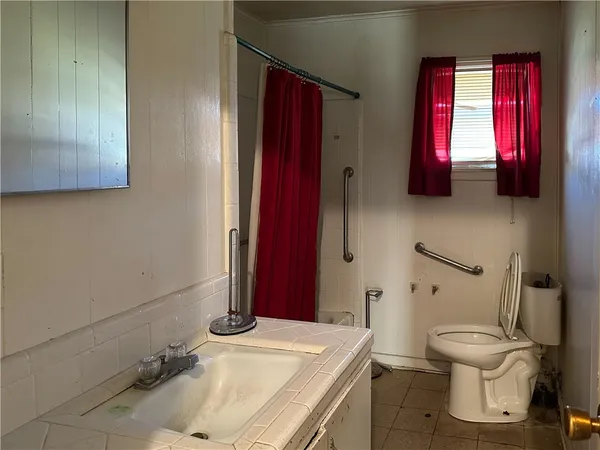 a bathroom with a toilet sink and window