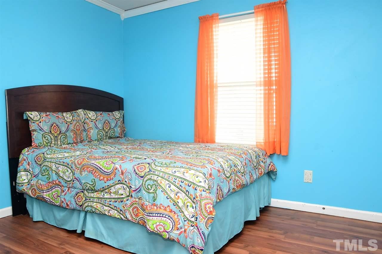5600 Orchard Gate Way Raleigh, NC 27616 - Photo 12 of 19 a bedroom with a bed and a window
