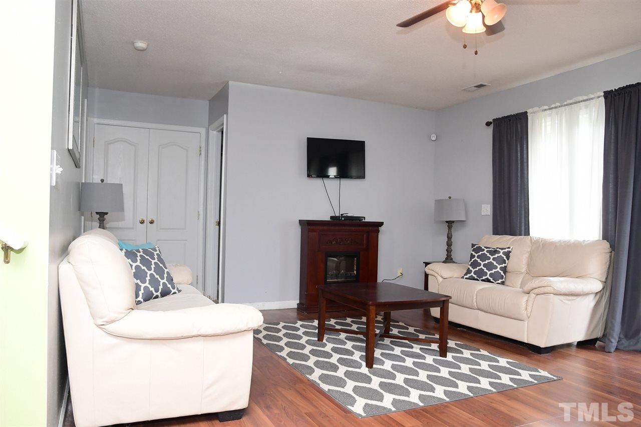 5600 Orchard Gate Way Raleigh, NC 27616 - Photo 16 of 19 a living room with furniture and a wooden floor