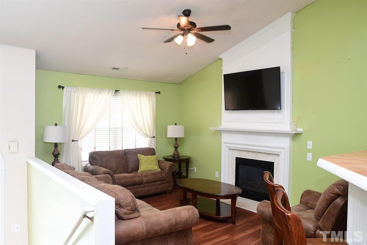 5600 Orchard Gate Way Raleigh, NC 27616 - Photo 9 of 19 a living room with furniture a fireplace and a flat screen tv